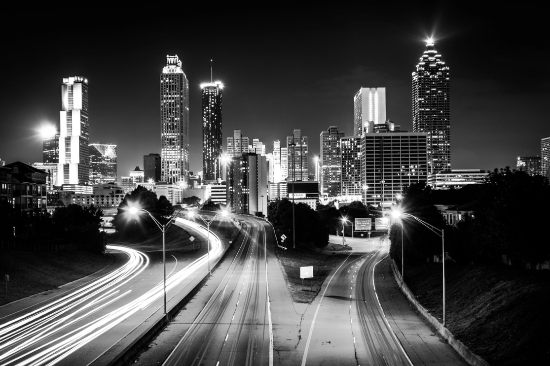 Downtown Atlanta skyline at night with highway traffic, the market Swartz Co searches for tenants